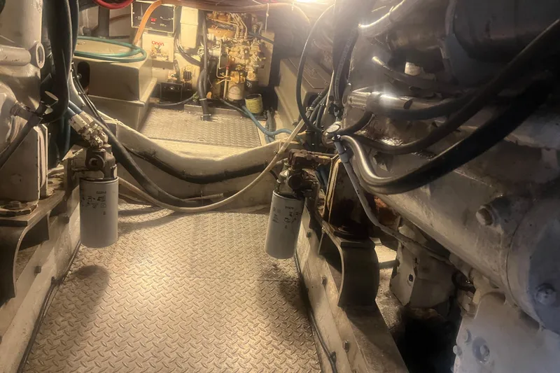 Slide: The Image of Engine room of a 1993 Bertram 37 Convertible boat, showcasing mechanical components and wiring. - 51