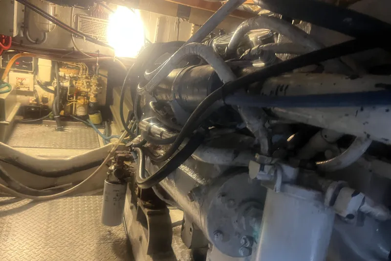 Slide: The Image of Engine room of a 1993 Bertram 37 Convertible boat, showcasing mechanical components and wiring. - 52
