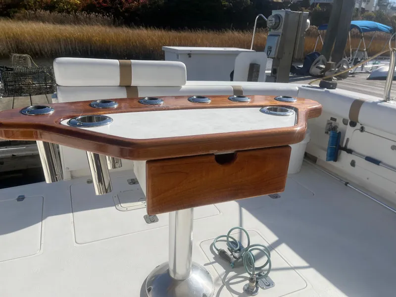 Slide: The Image of 1993 Bertram 37 Convertible fishing cockpit with rod holders and storage. - 9