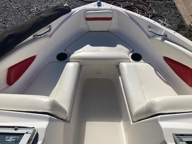 Slide: The Image of 2008 Regal 1900 Bowrider boat interior with white and red seating. - 10