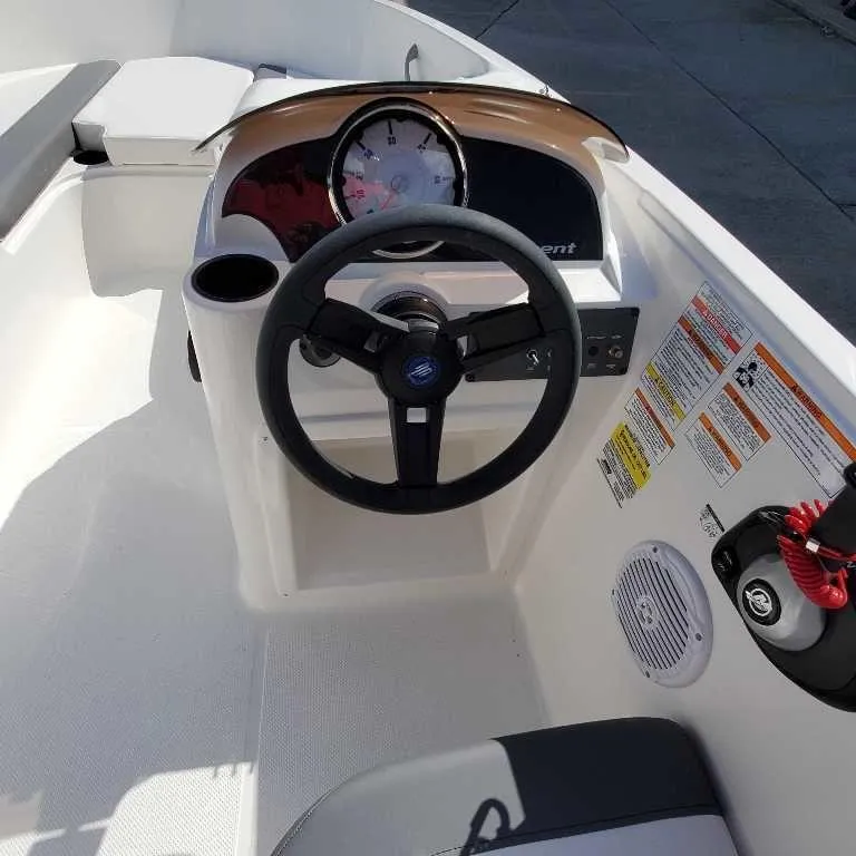 Slide: The Image of 2025 Bayliner E18 boat dashboard with steering wheel and control panel. - 3