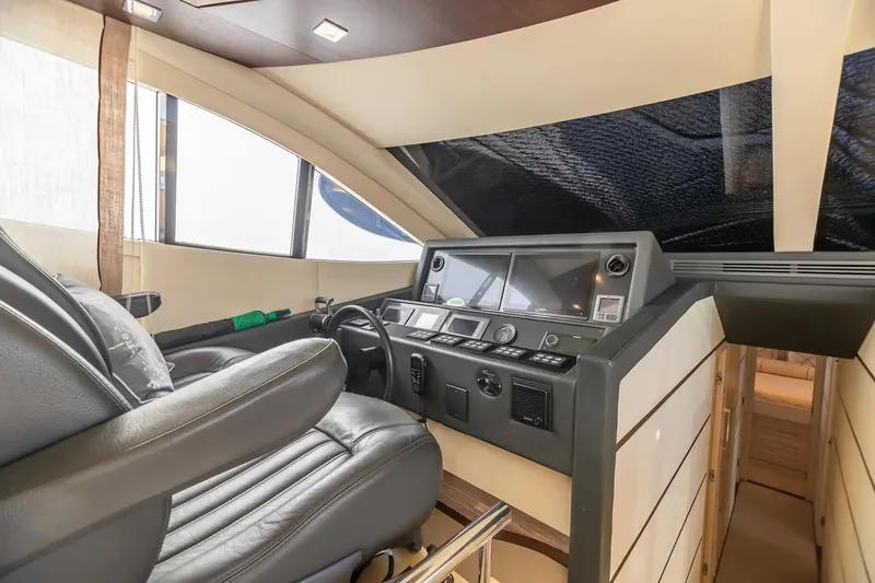 Slide: The Image of Interior helm of 2009 Uniesse 68 Sport Yacht with modern controls and leather seating. - 20