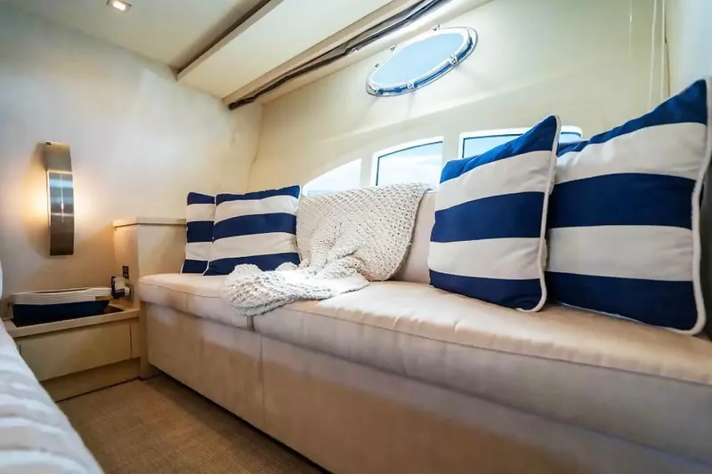 Slide: The Image of Luxurious interior of 2009 Uniesse 68 Sport Yacht with striped cushions and cozy blanket. - 27