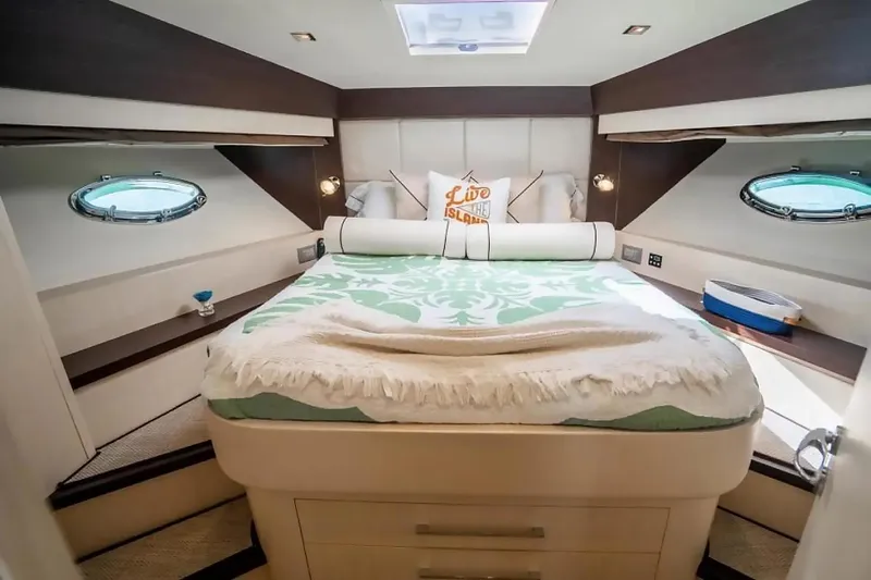 Slide: The Image of Luxurious bedroom in 2009 Uniesse 68 Sport Yacht with elegant bedding and porthole windows. - 30