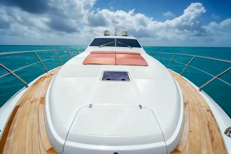 Slide: The Image of Uniesse 68 Sport Yacht 2009 on turquoise sea under cloudy sky. - 8