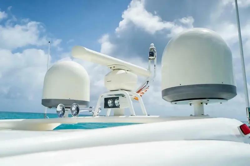 Slide: The Image of Uniesse 68 Sport Yacht 2009 radar equipment against a cloudy sky and turquoise sea. - 9