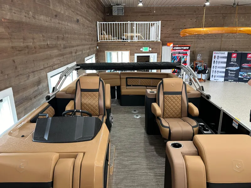 Slide: The Image of 2025 Godfrey Aqua Patio 235 ULC boat interior with luxurious tan seating and modern design. - 11