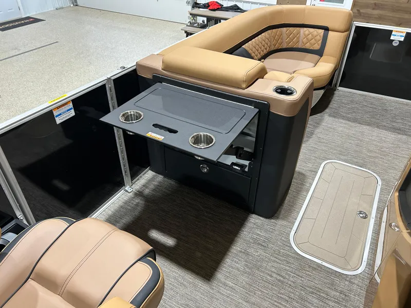 Slide: The Image of 2025 Godfrey Aqua Patio 235 ULC interior with tan seating and fold-out table. - 12