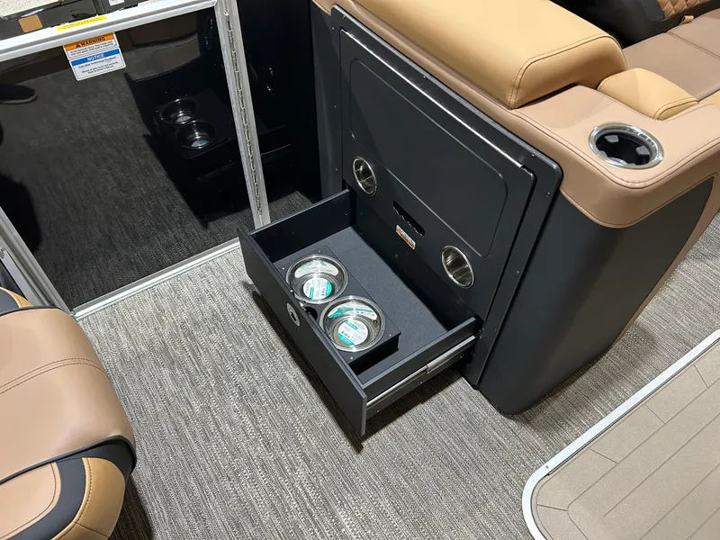 Slide: The Image of 2025 Godfrey Aqua Patio 235 ULC interior with open storage drawer and cup holders. - 13