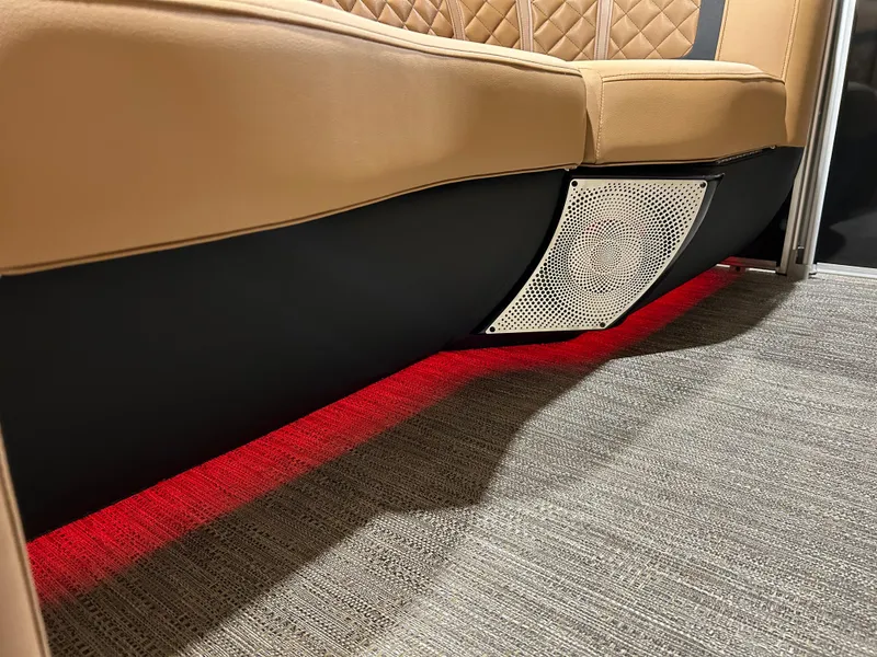 Slide: The Image of 2025 Godfrey Aqua Patio 235 ULC interior with ambient red lighting and cushioned seating. - 16