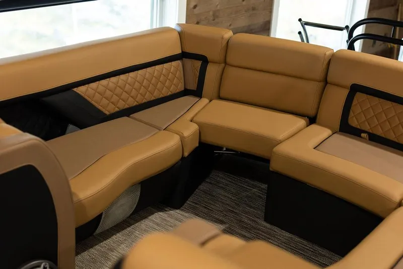 Slide: The Image of Luxurious seating on 2025 Godfrey Aqua Patio 235 ULC boat, featuring tan upholstery and quilted accents. - 18