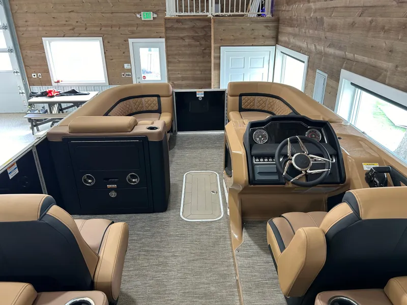 Slide: The Image of 2025 Godfrey Aqua Patio 235 ULC boat interior with luxurious seating and modern dashboard. - 5