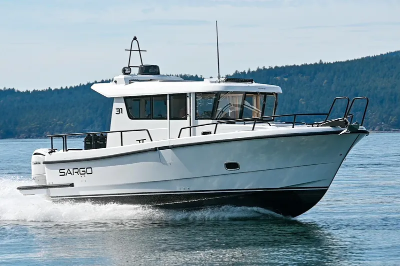 The Image of 2025 Sargo 31OB boat cruising on a calm lake with forested hills in the background. - 0