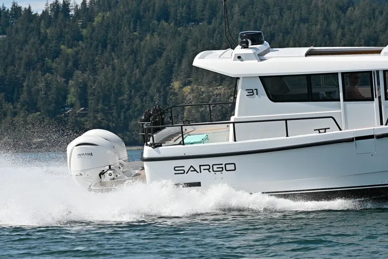 Slide: The Image of 2025 Sargo 31OB boat cruising on water with Yamaha outboard engine. - 10