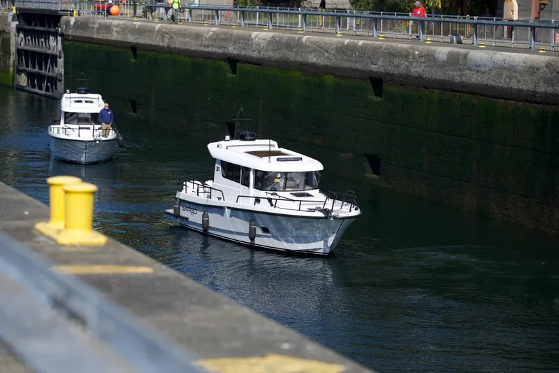 Slide: The Image of 2025 Sargo 31OB boat navigating through a canal lock. - 11