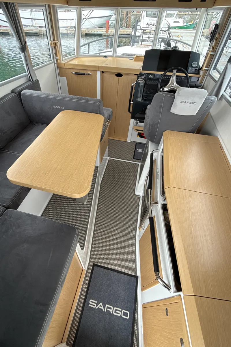 Slide: The Image of Interior of 2025 Sargo 31OB boat with modern seating and navigation area. - 13