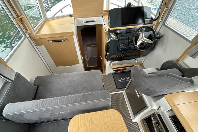Slide: The Image of Interior of 2025 Sargo 31OB boat with modern helm and seating. - 14