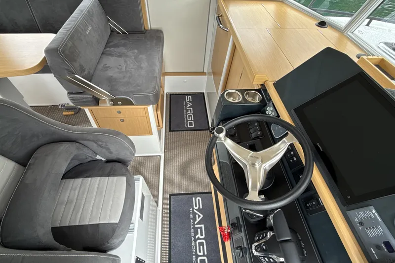 Slide: The Image of Interior of 2025 Sargo 31OB boat with modern steering and seating. - 16