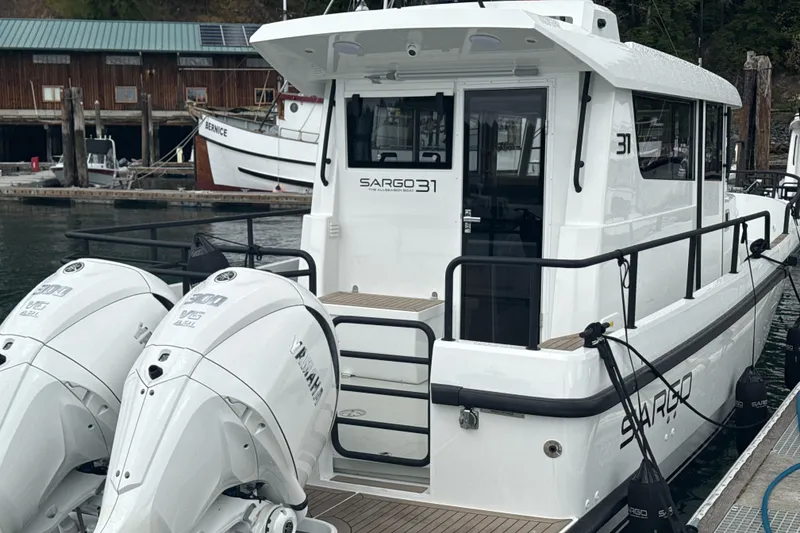 Slide: The Image of 2025 Sargo 31OB boat docked with twin Yamaha outboard engines. - 22