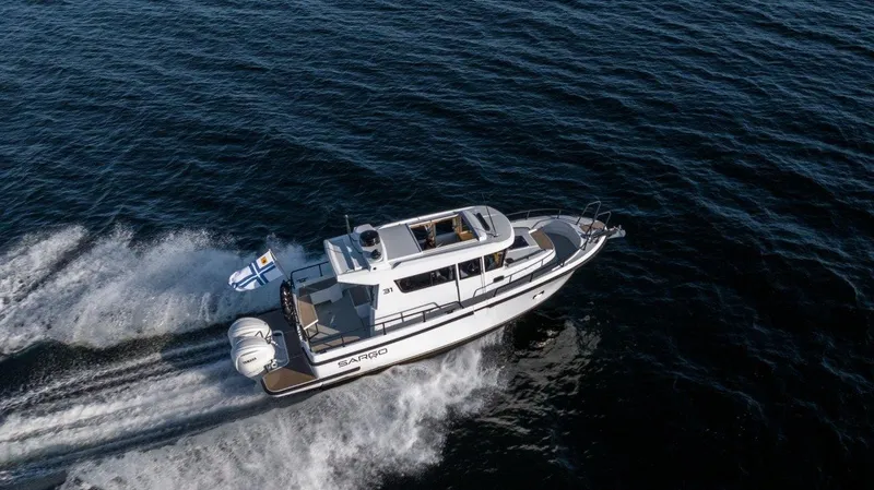 Slide: The Image of 2025 Sargo 31OB boat cruising on open water, aerial view. - 25