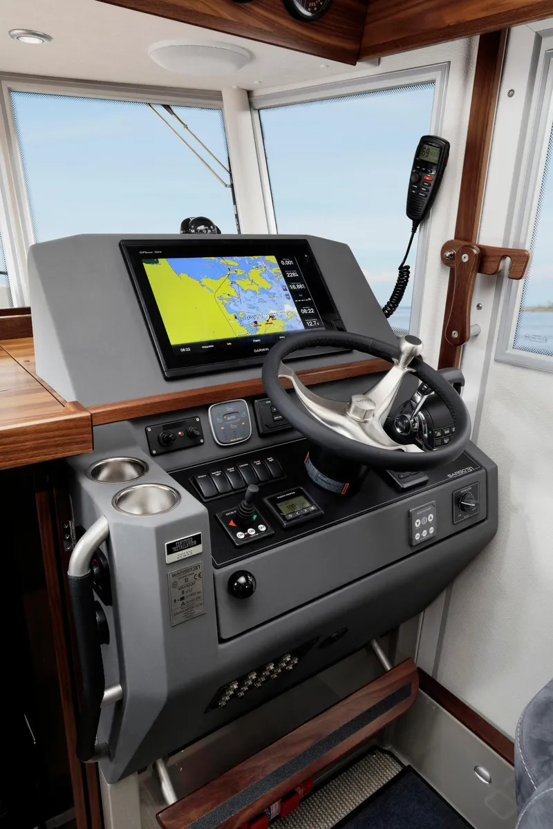 Slide: The Image of 2025 Sargo 31OB boat helm with navigation system and controls. - 27