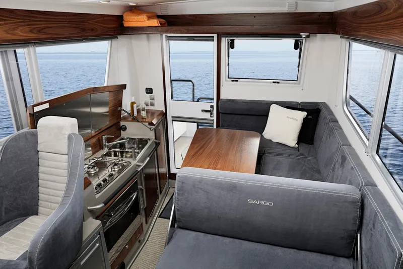 Slide: The Image of Interior of 2025 Sargo 31OB boat with kitchen and seating area. - 32