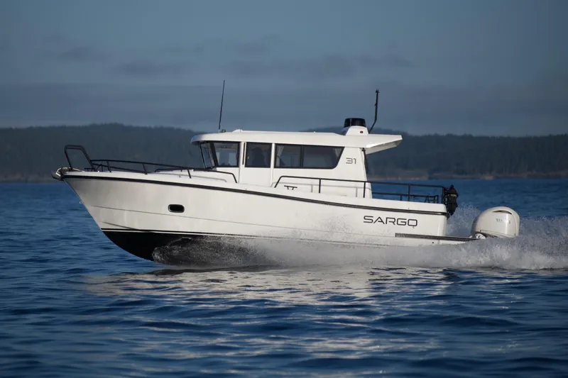 Slide: The Image of 2025 Sargo 31OB boat cruising on open water. - 9