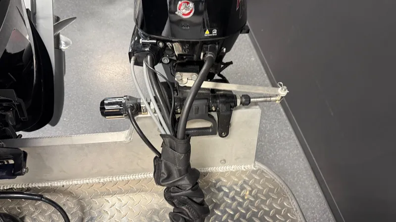 Slide: The Image of Outboard motor of 2025 Hewescraft 240 Ocean Pro ET HT on diamond plate flooring. - 16