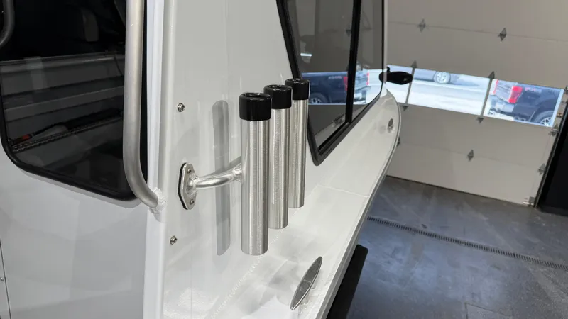 Slide: The Image of 2025 Hewescraft 240 Ocean Pro ET HT boat with rod holders in a garage. - 19