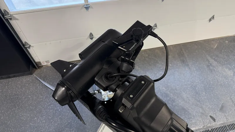 Slide: The Image of Outboard motor detail of 2025 Hewescraft 240 Ocean Pro ET HT in a garage setting. - 23