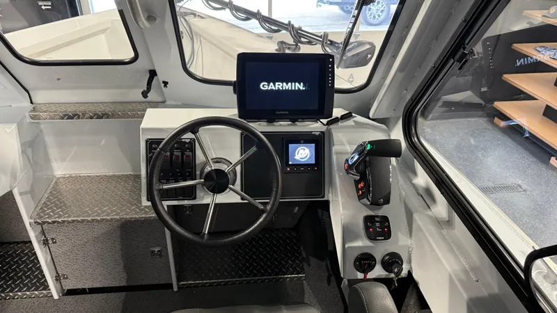 Slide: The Image of 2025 Hewescraft 240 Ocean Pro ET HT boat cockpit with Garmin navigation system. - 24