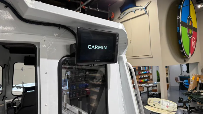 Slide: The Image of 2025 Hewescraft 240 Ocean Pro ET HT with Garmin display in showroom. - 25