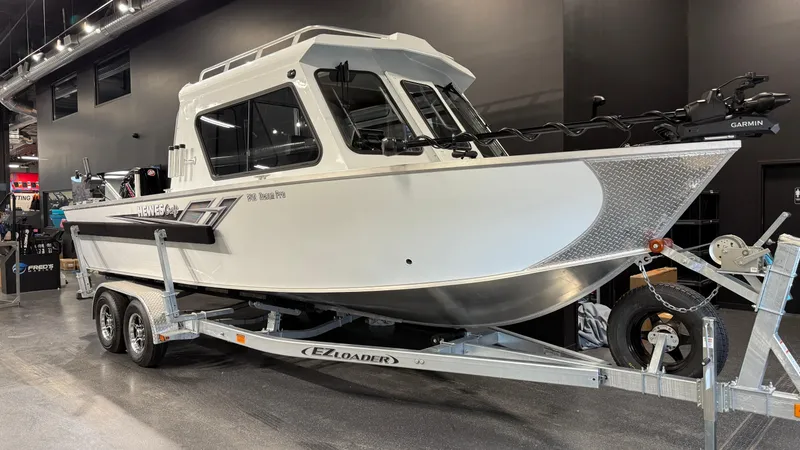 Slide: The Image of 2025 Hewescraft 240 Ocean Pro ET HT boat on trailer in showroom. - 3
