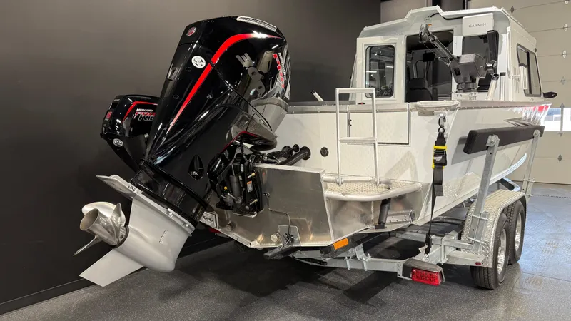 Slide: The Image of 2025 Hewescraft 240 Ocean Pro ET HT boat with powerful outboard motor on trailer. - 5