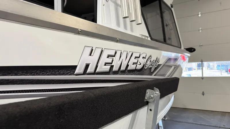 Slide: The Image of 2025 Hewescraft 240 Ocean Pro ET HT boat in a garage, close-up view. - 6