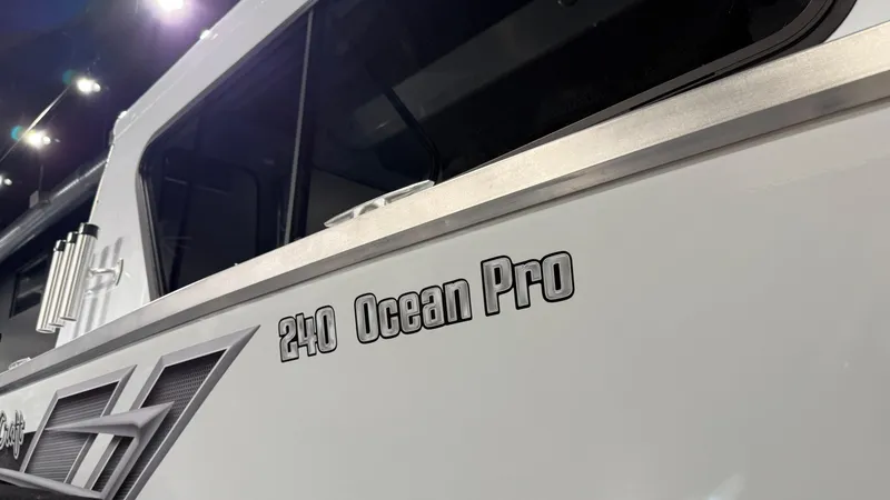 Slide: The Image of 2025 Hewescraft 240 Ocean Pro ET HT boat, close-up of model name on hull. - 7