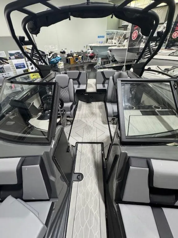 Slide: The Image of 2025 Yamaha Boats 222XD interior with sleek seating and modern design in showroom. - 2