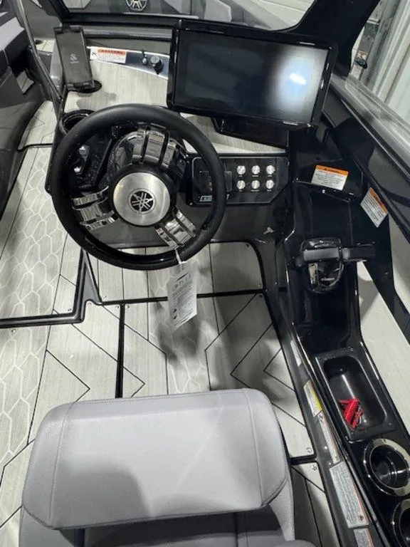 Slide: The Image of 2025 Yamaha Boats 222XD cockpit with steering wheel, touchscreen, and modern controls. - 4