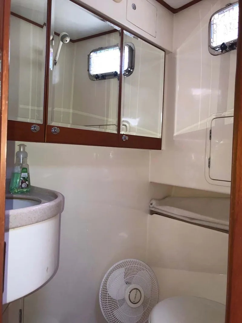 Slide: The Image of 2004 Selene Trawler bathroom with sink, mirror, and fan. - 22