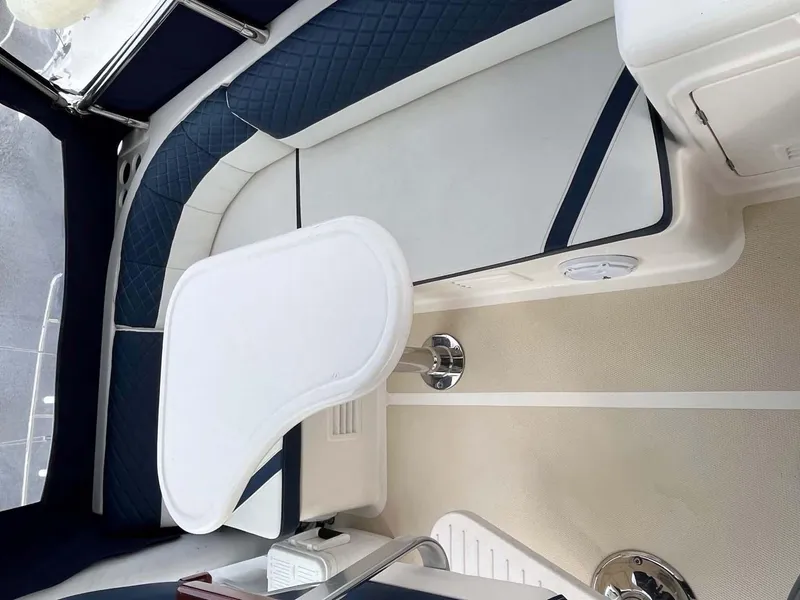 Slide: The Image of 2004 Selene Trawler interior with blue and white seating and a foldable table. - 28