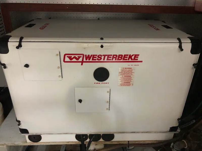 Slide: The Image of Westerbeke generator on 2004 Selene Trawler, white casing with red logo and fire port. - 41