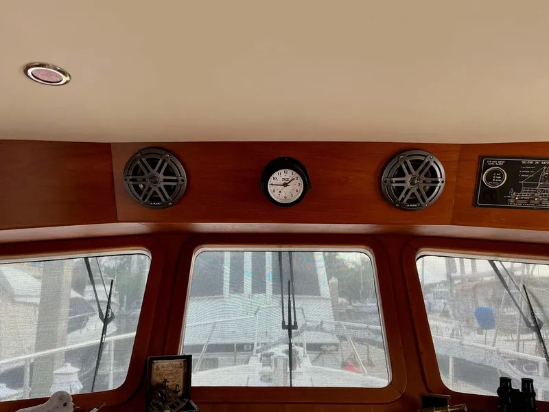 Slide: The Image of Interior view of a 2004 Selene Trawler with clock and speakers on wooden panel. - 8
