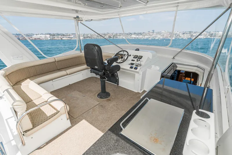 Slide: The Image of 2008 Navigator 62 Pilothouse interior with helm, seating, and ocean view. - 13