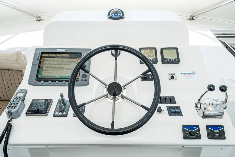 Slide: The Image of 2008 Navigator 62 Pilothouse helm with steering wheel and navigation controls. - 15