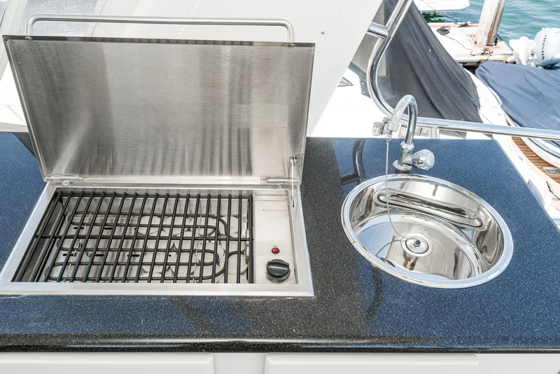 Slide: The Image of Outdoor grill and sink on 2008 Navigator 62 Pilothouse yacht deck. - 17