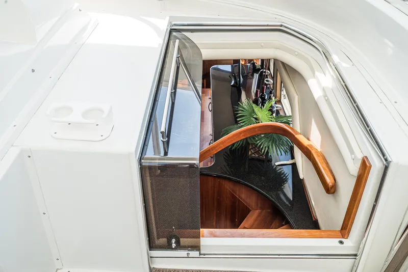 Slide: The Image of 2008 Navigator 62 Pilothouse interior staircase with wooden handrail and modern design. - 20