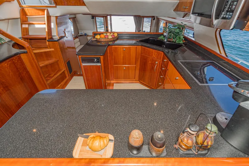 Slide: The Image of Luxurious kitchen interior of 2008 Navigator 62 Pilothouse yacht with wooden cabinetry and modern appliances. - 32