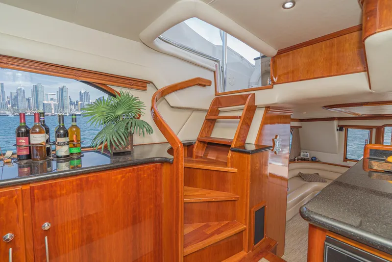 Slide: The Image of Luxurious 2008 Navigator 62 Pilothouse interior with wooden stairs and city skyline view. - 35
