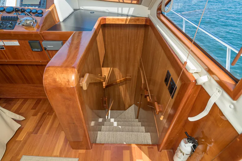 Slide: The Image of Interior staircase of 2008 Navigator 62 Pilothouse yacht with wooden finish. - 42