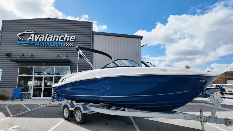 The Image of 2025 Bayliner VR6 boat on trailer outside Avalanche Motorsports building. - 1